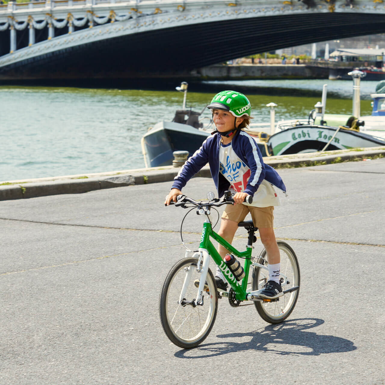 Child standing up on pedals on woom bike