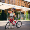 Child riding woom bike with POP basket fitted