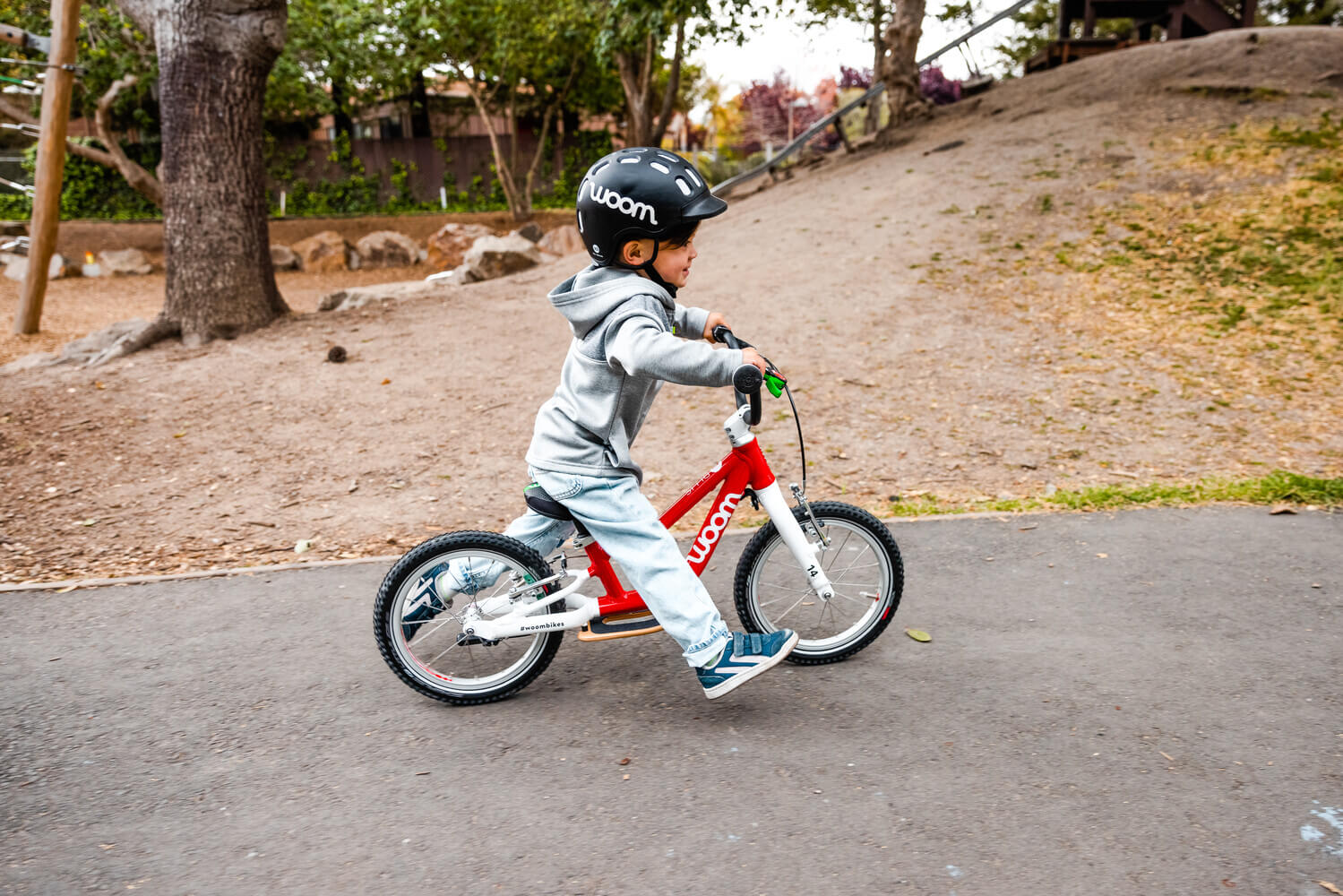Child riding woom balance bike
