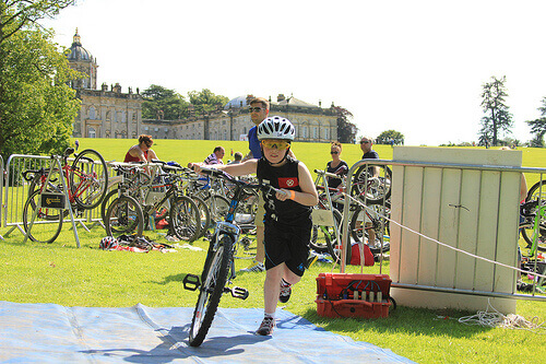 boy on bike junior triathlon transition