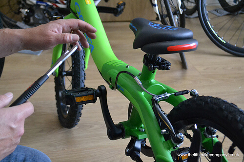 Taking the pedals off a bike to help a child learn to balance